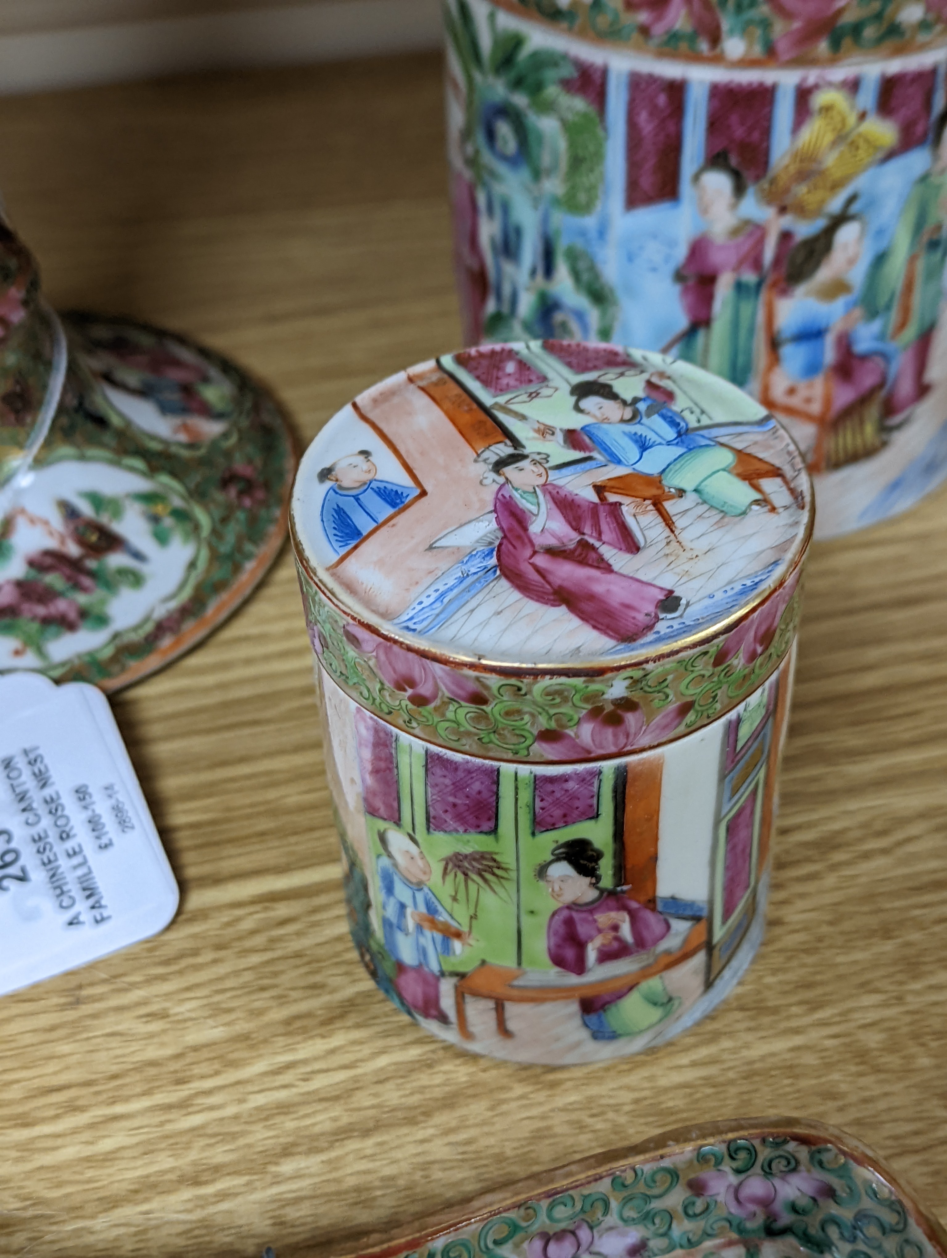 A Chinese Canton famille rose nest of boxes and covers, a similar candlestick and a tray 23cm